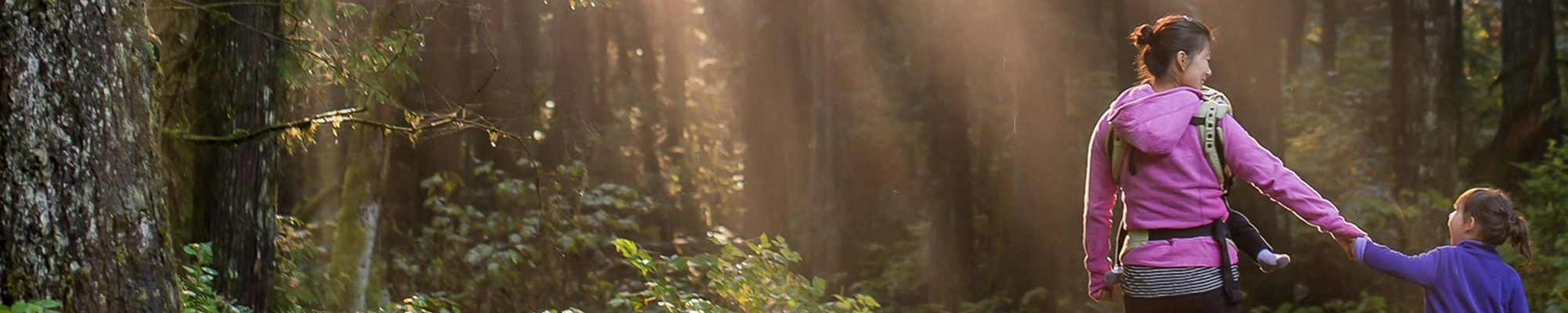 parent and child walking in the woods
